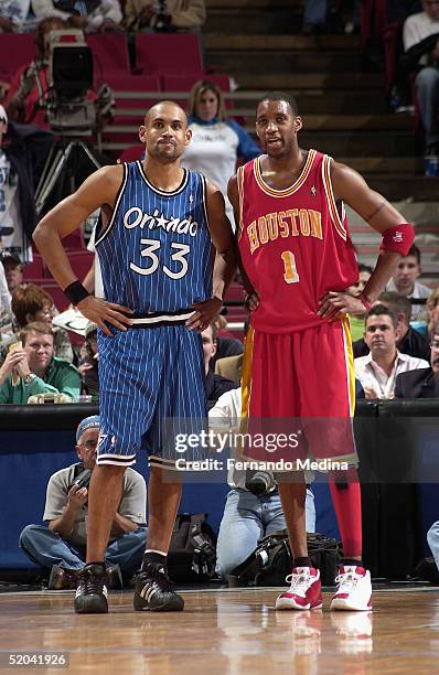Grant Hill of the Orlando Magic stands next to former teammate Tracy McGrady the Houston Rockets at TD Waterhouse Centre on January 20, 2005 in...