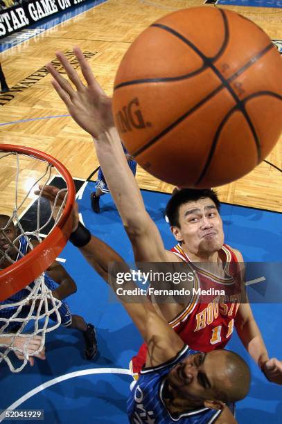 Yao Ming of the Houston Rockets attempts to block a shot against Grant Hill of the Orlando Magic at TD Waterhouse Centre on January 20, 2005 in...