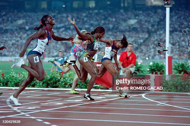 Gwen Torrence, Merlene Ottey of Jamaica and US Gail Devers cross the finish line in the Olympic women's 100m dash, on July 27, 1996. Devers won the...