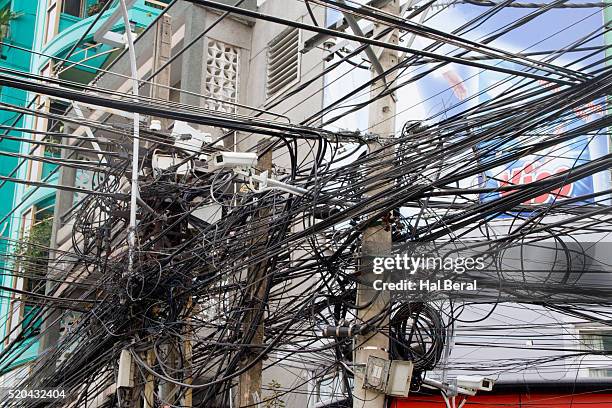 tangle of power lines on power pole - telephone line stock pictures, royalty-free photos & images