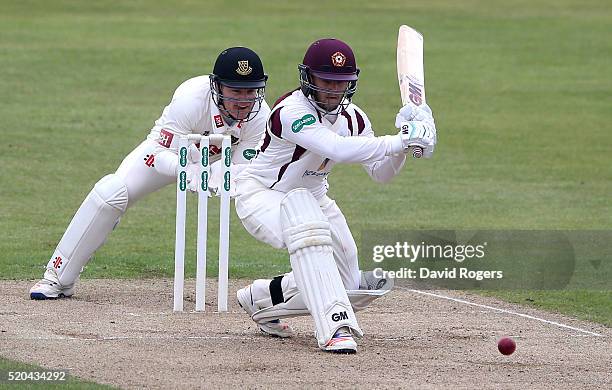 Ben Duckett of Northamptonshire sweeps the ball for four runs during the Specsavers County Championship division two match between Northamptonshire...
