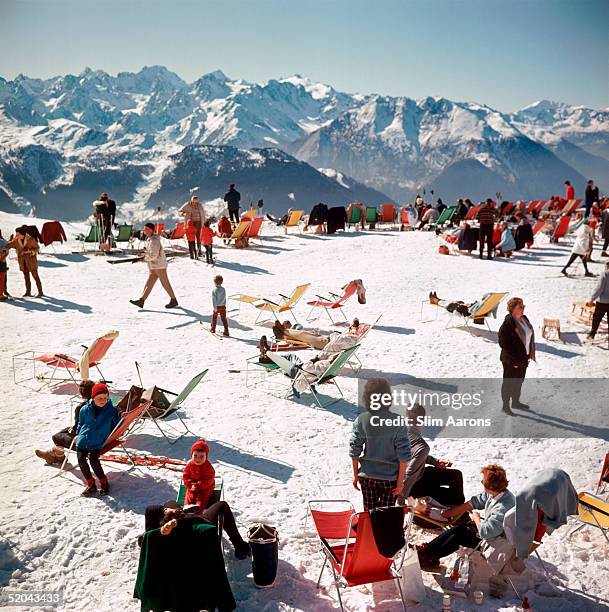 Holiday-makers take the sun on a mountain top in Verbier, 1964.