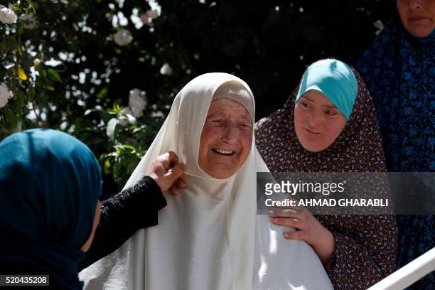 Relatives of Abed Dawiyat react as they stand at the entrance of their home after Israeli forces sealed off the building in the Palestinian east...