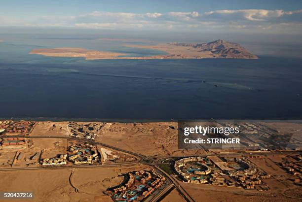 Picture taken on January 14, 2014 through the window of an airplane shows the Red Sea's Tiran and the Sanafir islands in the Strait of Tiran between...