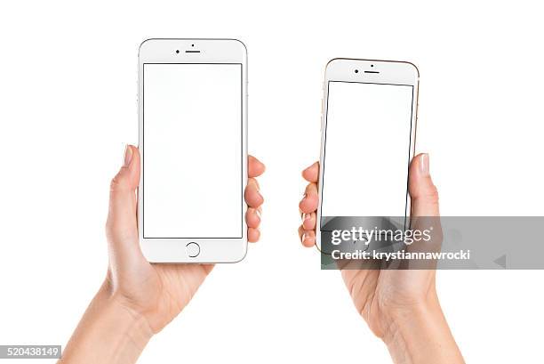 holding iphone 6 and iphone 6 plus with white screen - holding iphone stockfoto's en -beelden