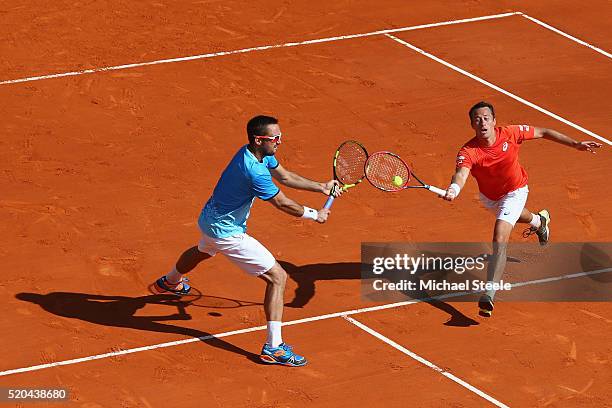 Philipp Kohlschreiber of Germany and Viktor Troicki of Serbia hit a return against Fernando Verdasco and Rafael Nadal of Spain during day two of the...