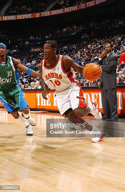 Royal Ivey of the Atlanta Hawks moves the ball against Jason Terry of the Dallas Mavericks during the game at Philips Arena on December 22, 2004 in...