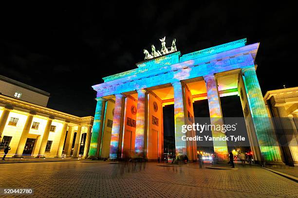 the brandenburg gate - brandenburger tor in berlin illuminated at the festival of lights - berlin night stock pictures, royalty-free photos & images