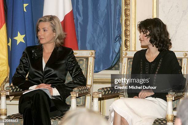 Audrey Tautou waits alongside Laurence Ferrari at a ceremony in which she and Daniel Bruehl received the Adenauer-de-Gaulle prize January 21, 2005 at...