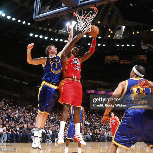 Marc Jackson of the Philadelphia 76ers grabs a rebound against Troy Murphy of the Golden State Warriors during a game at The Arena in Oakland on...