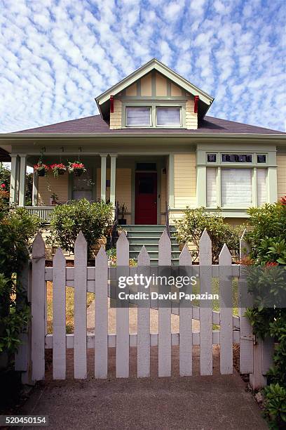 yellow home behind picket fence - white picket gate stock pictures, royalty-free photos & images