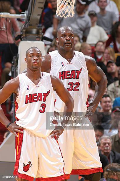 Dwyane Wade and Shaquille O'Neal of the Miami Heat look on against the Indiana Pacers during NBA action on January 21, 2005 at American Airlines...