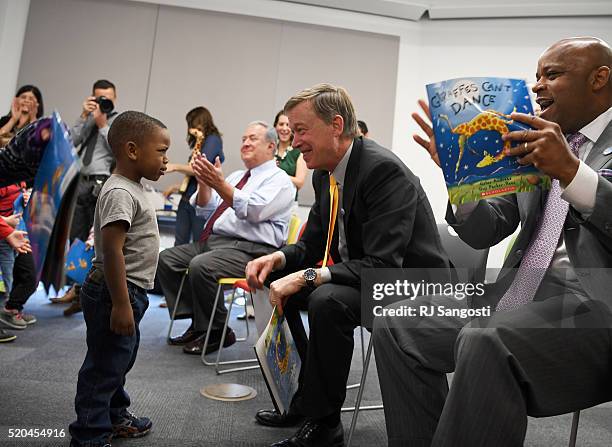 Three-year-old Tre Hickmon-Lewis just peers at Colorado Governor John Hickenlooper when he was asked him if he could dance like the giraffe in the...