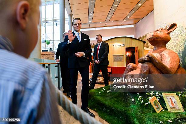 Prince Daniel of Sweden waves to four year old Pontus during the opening of the exhibition 'Frech, wild & wunderbar - schwedische Kinderbuchwelten'...