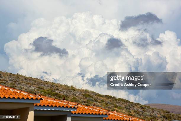 a thunder cell build up of cumulo nimbus clouds over lesvos, greece - cumulo stock pictures, royalty-free photos & images