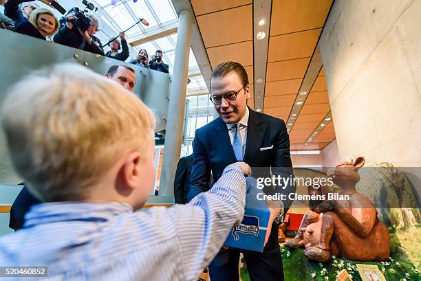 Four year old Pontus hands over a baby romper suit in a present box reading the name of German capitols football club 'Hertha BSC' in a attends the...