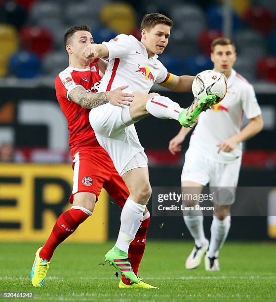 Sercan Sarare of Duesseldorf challenges Dominik Kaiser of Leipzig during the Second Bundesliga match between Fortuna Duesseldorf and RB Leipzig at...