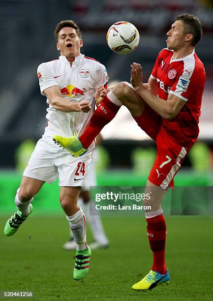 Dominik Kaiser of Leipzig is challenged by Oliver Fink of Duesseldorf during the Second Bundesliga match between Fortuna Duesseldorf and RB Leipzig...