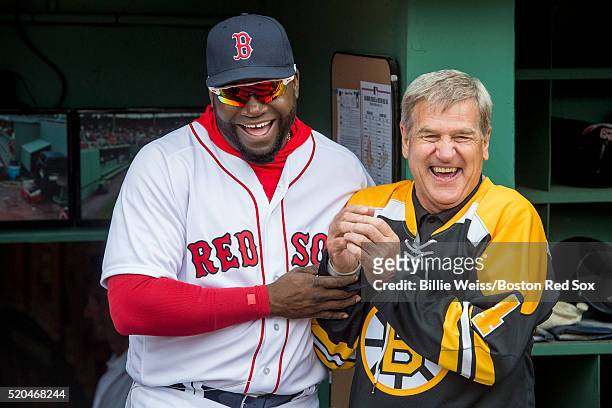 David Ortiz of the Boston Red Sox and former Boston Bruins player Bobby Orr react before throwing a ceremonial first pitch during the home opener...