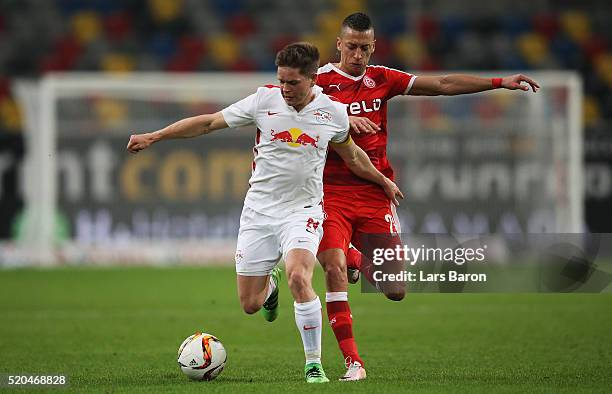 Dominik Kaiser of Leipzig is challenged by Nikola Djurdjic of Duesseldorf during the Second Bundesliga match between Fortuna Duesseldorf and RB...