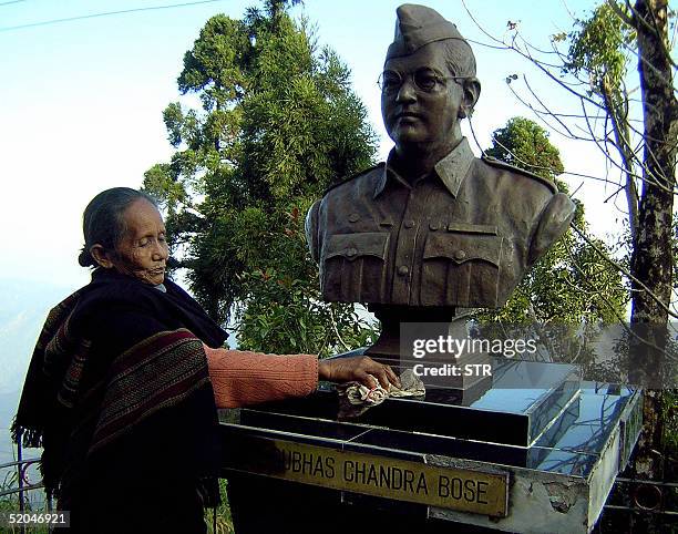 Year old Indian woman Motimaya Lepcha polishes a statue of Indian freedom fighter Subhash Chandra Bose in the town of Gidda Pahar, some 50kms north...