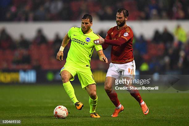 Danny Fox of Nottingham Forest makes a tackle on Tomer Hemed of Brighton and Hove Albion during the Sky bet Championship match between Nottingham...