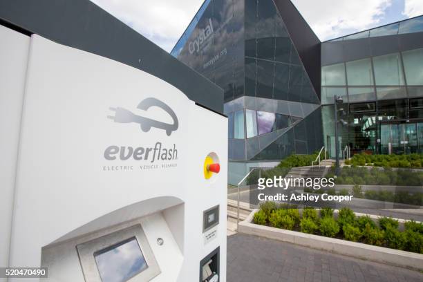 an electric vehicle recharging station at the crystal building - siemens stock pictures, royalty-free photos & images