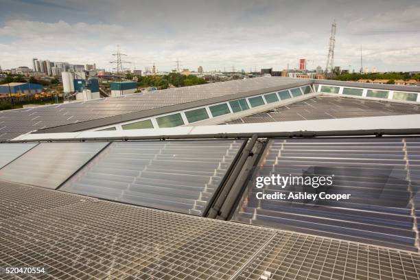 solar thermal and solar pv panels on the roof of the crystal building - siemens stock pictures, royalty-free photos & images