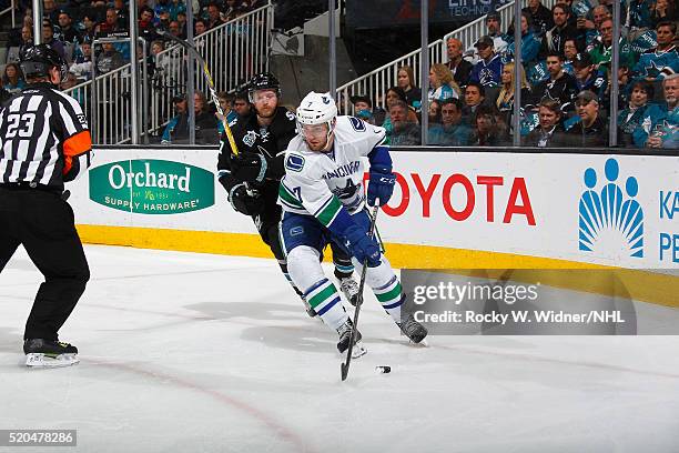 Linden Vey of the Vancouver Canucks skates with the puck against Paul Martin of the San Jose Sharks at SAP Center on March 31, 2016 in San Jose,...