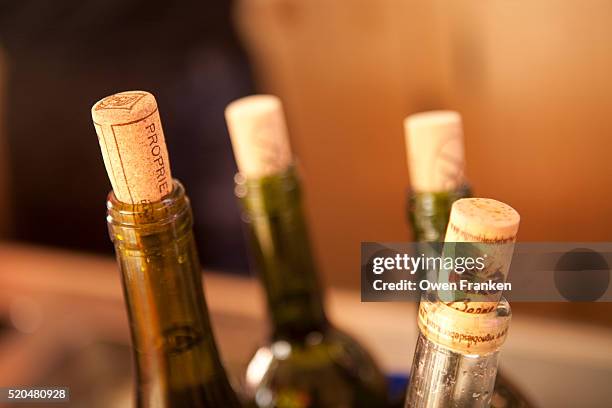 bottlenecks and corks at the counter of a wine bar in paris - wine cork stock pictures, royalty-free photos & images
