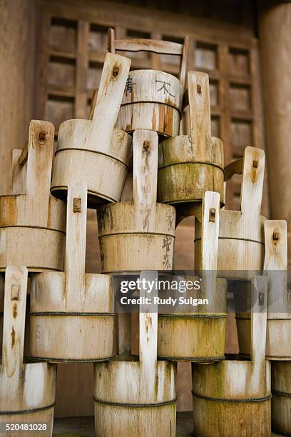 buckets stacked at yasaka shrine in kyoto - yasaka shrine stock pictures, royalty-free photos & images