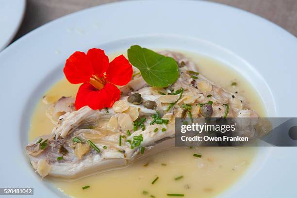 a skate wing (aile de raie) served with a white wine sauce of pickled lemon, almonds, capers, chives - nasturtium fotografías e imágenes de stock