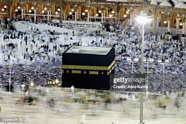 Muslim pilgrims circumambulate as others perform the last prayer around the holy Kaaba at Mecca's Grand Mosque to finish the annual hajj rituals...