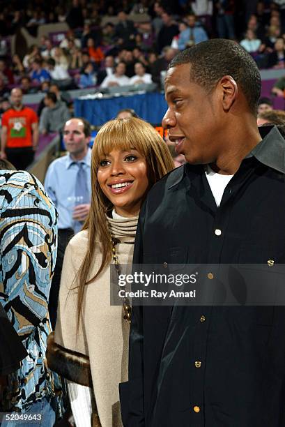 Beyonce and Jay-Z stand courtside at the New York Knicks vs Houston Rockets NBA game at Madison Square Garden on January 21, 2005 in New York City....