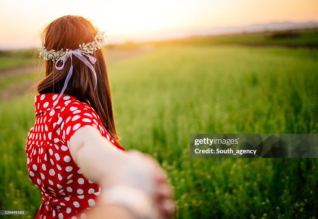 Holding her hand on a filed