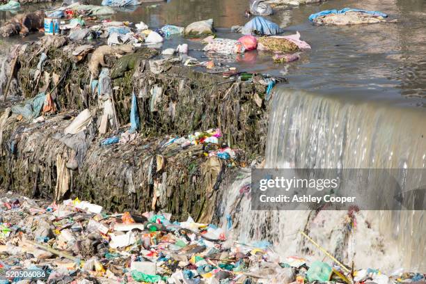 the highly polluted bishnumati river running through kathmandu in nepal. - river pollution stock pictures, royalty-free photos & images