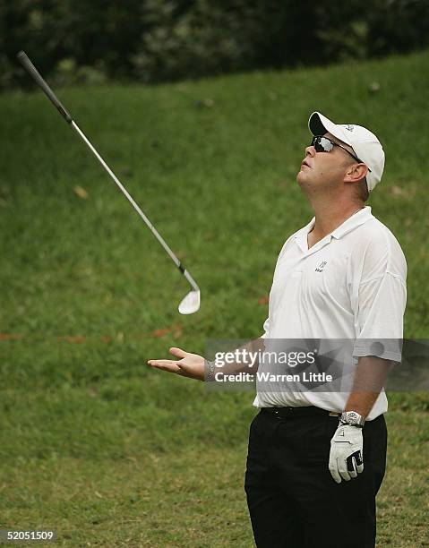 Titch Moore of South Africa throws his club up in the air after missing a chip for birdie on the fourth hole during the final round of South African...