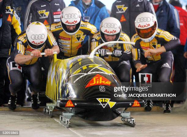 Switzerland's bobsleigh 1, Andi Gees Cedric Grand , Beat Hefti and Martin Annen prepare to start, 23 January 2005 at Cesana Pariol , for the 1st run...