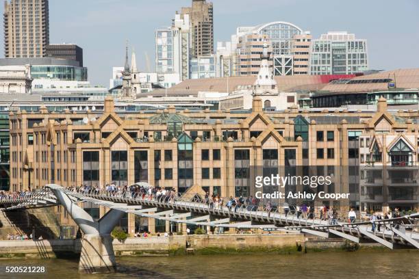 the millennium bridge crossing the river thames to tate modern in london, uk - tate modern stock-fotos und bilder