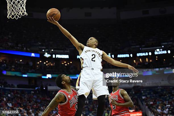 Tim Frazier of the New Orleans Pelicans drives to the basket against Aaron Brooks of the Chicago Bulls during the first half of a game at the...