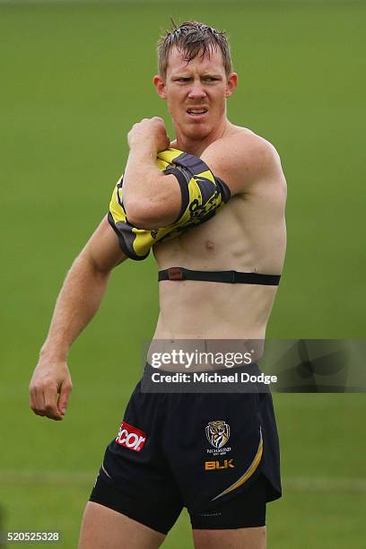 Jack Riewoldt of the Tigers takes off his jumper during a Richmond Tigers AFL media session at ME Bank Centre on April 12, 2016 in Melbourne,...