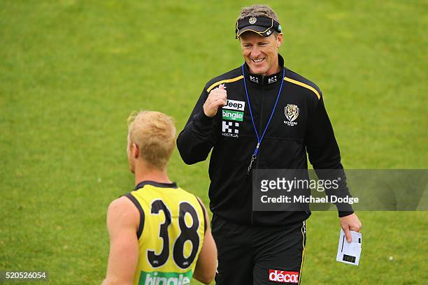 Tigers head coach Damien Hardwick speaks to Steven Morris during a Richmond Tigers AFL media session at ME Bank Centre on April 12, 2016 in...