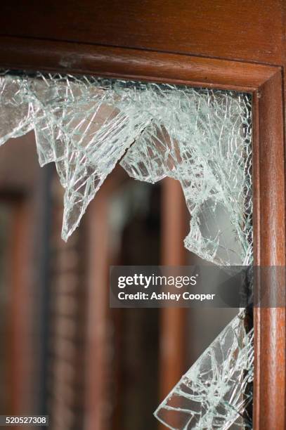 shattered window pane in door - carlisle cumbria stock pictures, royalty-free photos & images