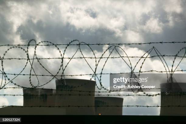 towers and barbed wire at drax power station - barbed wire stock pictures, royalty-free photos & images