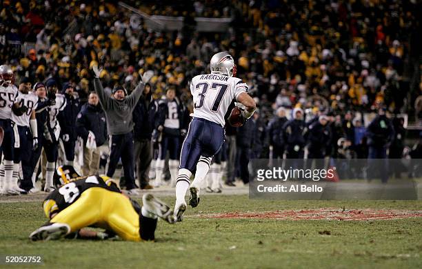Jerame Tuman of the Pittsburgh Steelers misses a tackle as Rodney Harrison of the New England Patriots returns an interception for a touchdown in the...