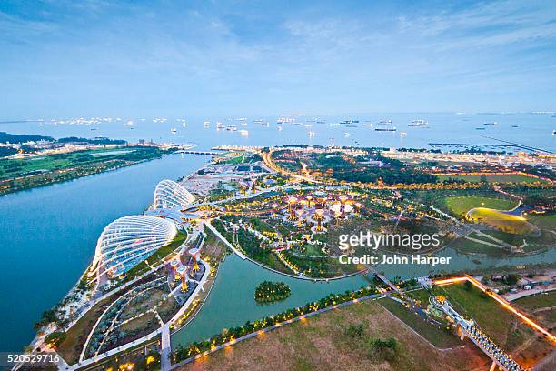 aerial of gardens by the bay, the singapore strait, singapore - singapore gardens stock-fotos und bilder