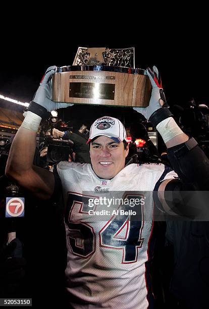 Tedy Bruschi of the New England Patriots holds up the Lamar Hunt trophy after the Patriots' 41-27 victory over the Pittsburgh Steelers in the AFC...