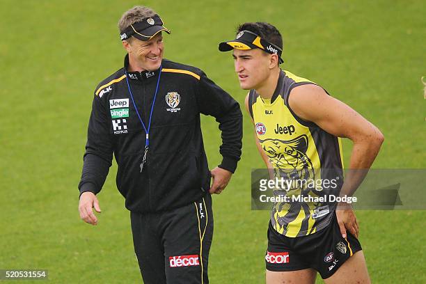Tigers head coach Damien Hardwick speaks to Ivan Soldo during a Richmond Tigers AFL media session at ME Bank Centre on April 12, 2016 in Melbourne,...