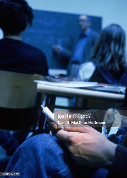 schoolboy holding joint in the classroom - spinello foto e immagini stock