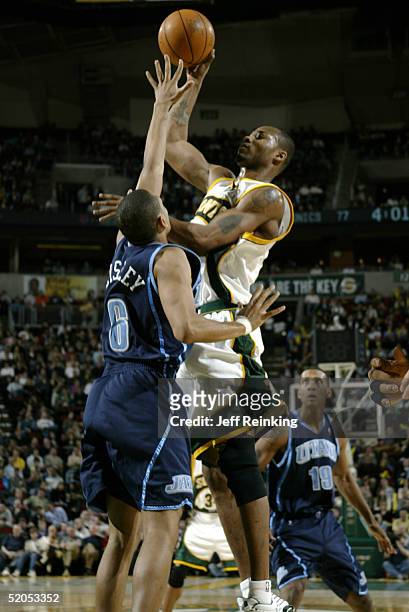 Rashard Lewis of the Seattle SuperSonics shoots over Howard Eisley of the Utah Jazz on January 23, 2005 at Key Arena in Seattle, Washington. The...